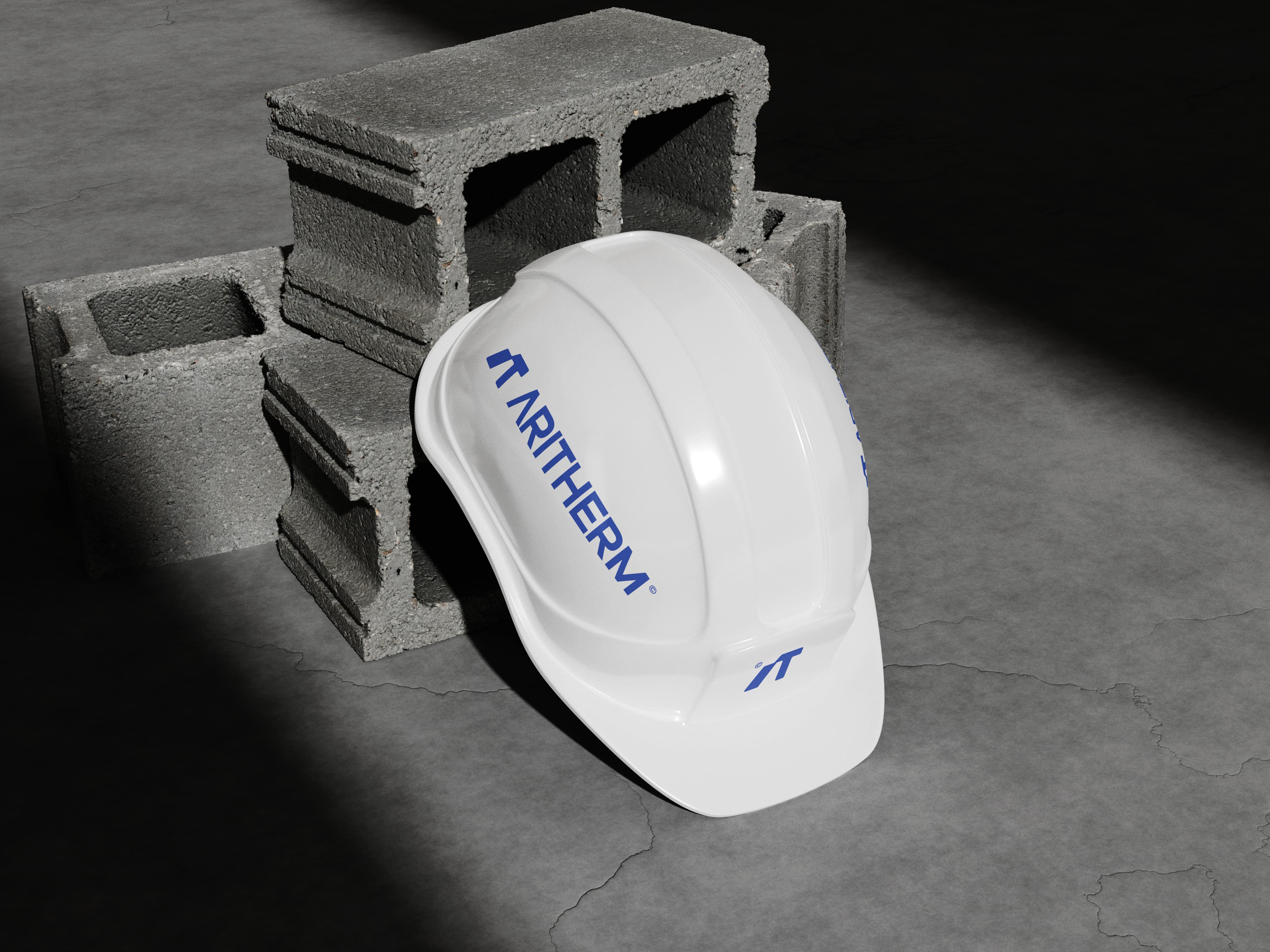 Aritherm logo applied to a white construction safety helmet as part of the industrial brand identity system.